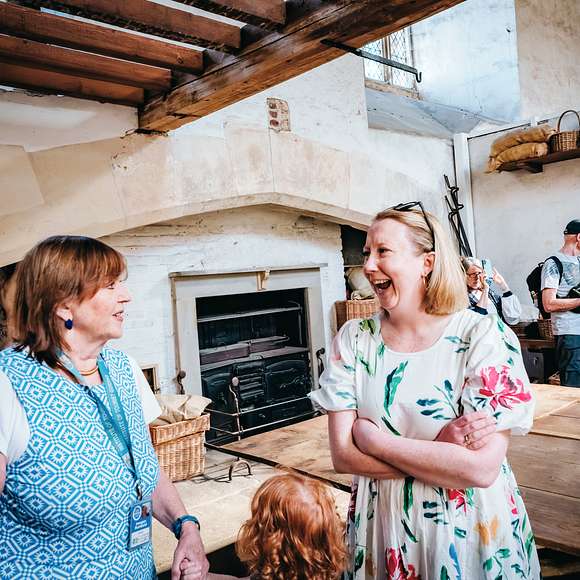 A visitor enjoying the explanation of the historical Tudor  kitchens