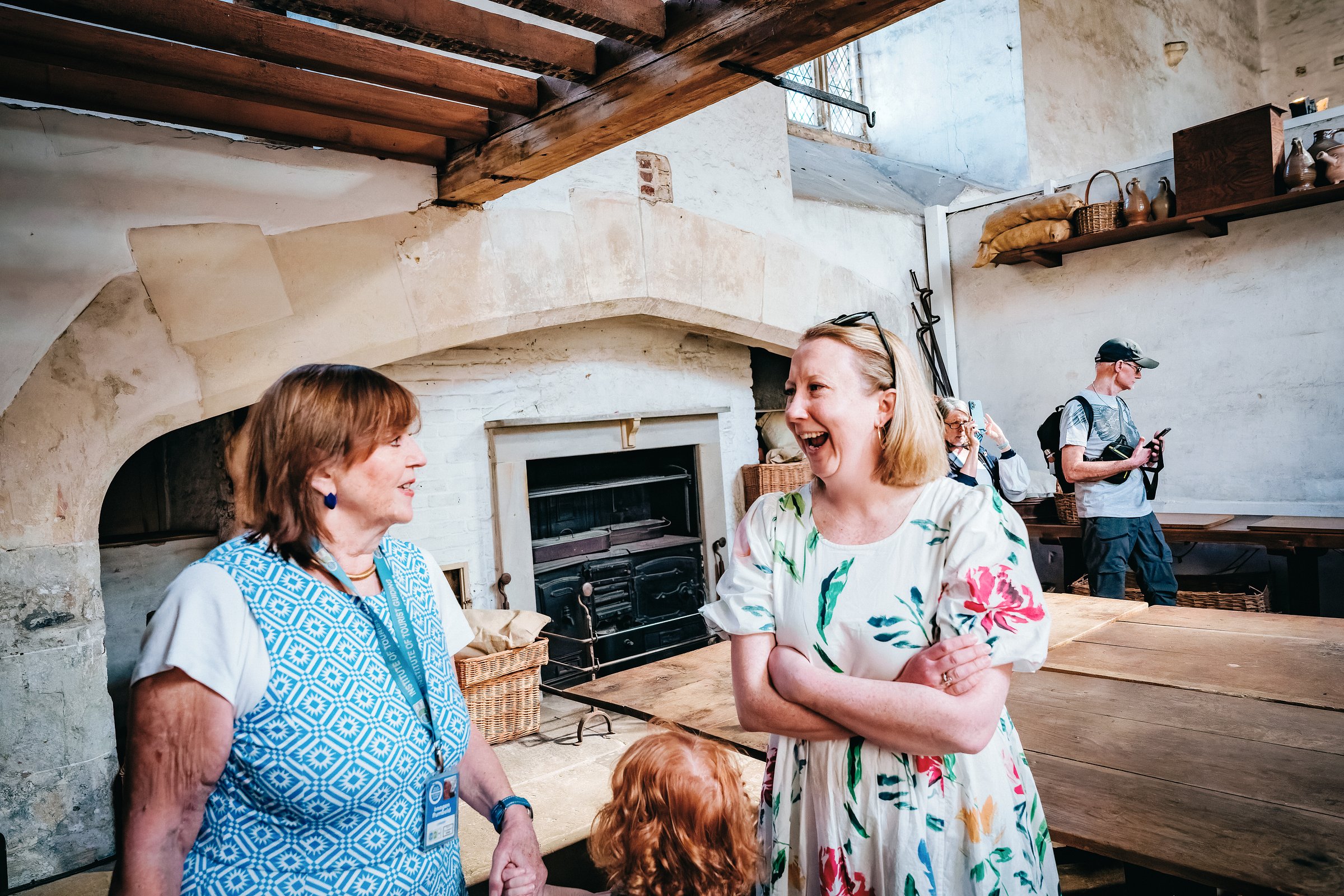 A visitor enjoying the explanation of the historical Tudor  kitchens