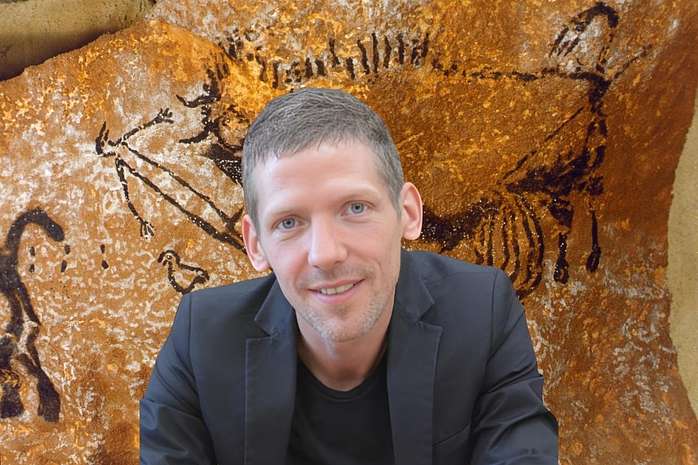 Prehistoric Cave Artwork with an Archaeologist