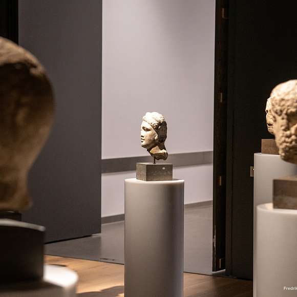 Stone busts on pedestals in a dimly lit gallery at the National Museum of Norway.