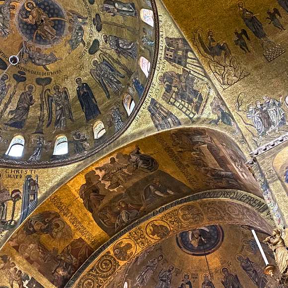 Golden mosaics of saints and biblical scenes decorate the domes and arches of St. Mark’s Basilica.