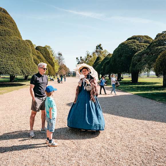 A visitor talking to a volunteer dressed as Queen Victoria 