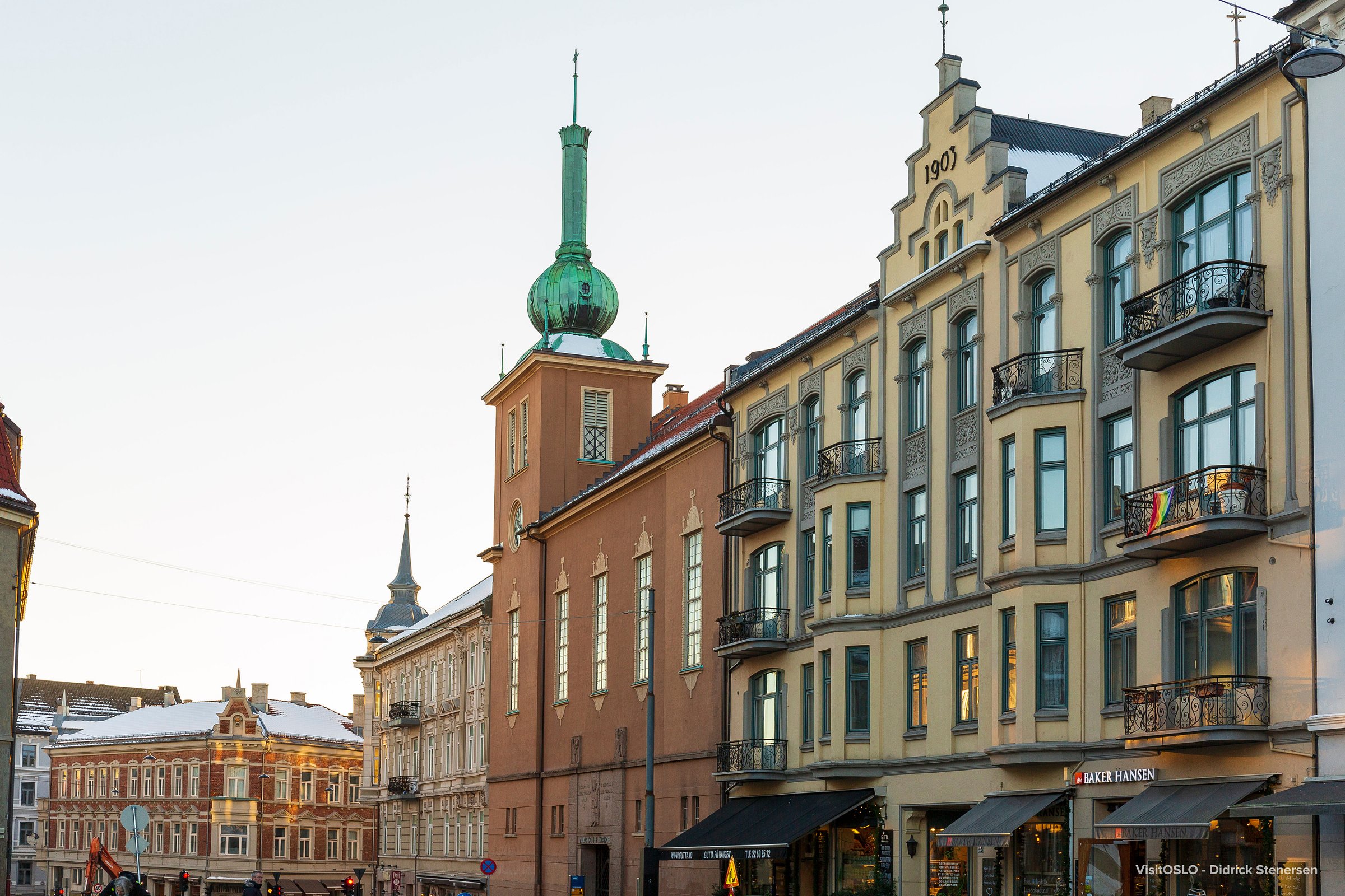 Historic buildings with ornate facades and green copper spires in central Oslo.