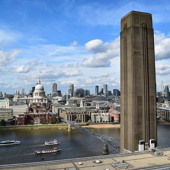 Skyline view of London from Tate Modern, featuring the Millennium Bridge and St. Paul’s Cathedral across the River Thames.